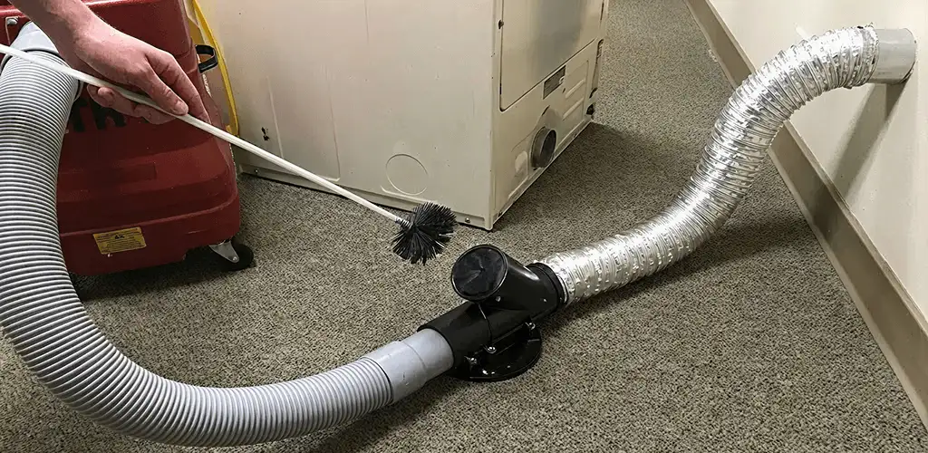 Dryer vent cleaning service removing lint from a dryer duct connection in Pittsburgh, PA