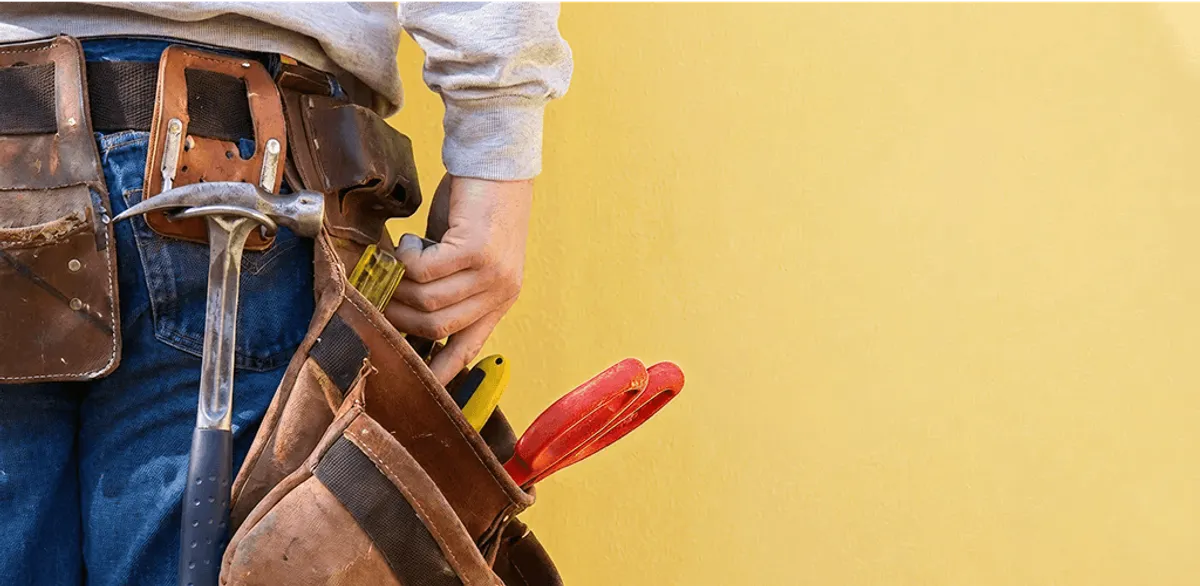 Handyman with tool belt ready for home repairs and maintenance in Pittsburgh, PA