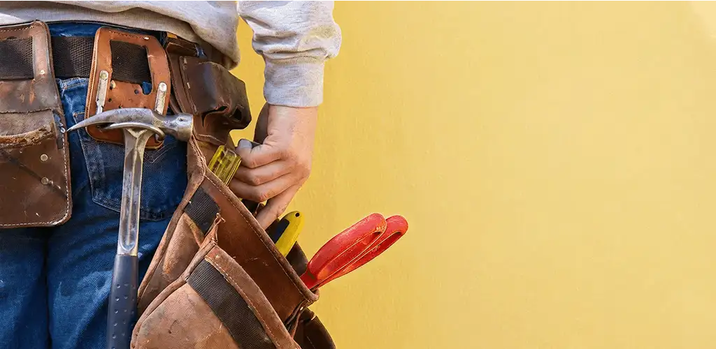 Handyman with tool belt ready for home repairs and maintenance in Pittsburgh, PA