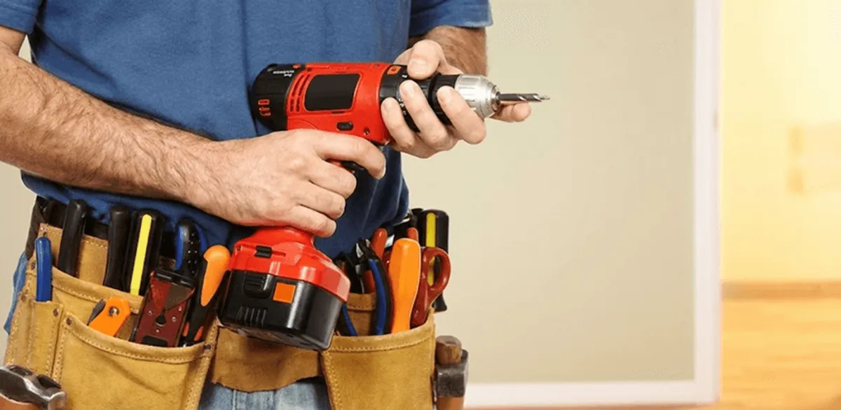 Handyman holding a power drill for home repairs and installations in Pittsburgh, PA