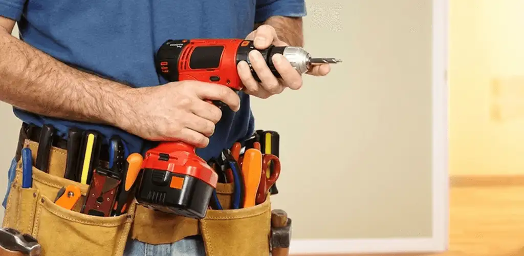 Handyman holding a power drill for home repairs and installations in Pittsburgh, PA