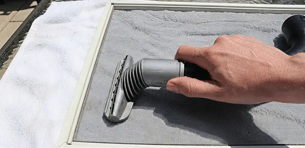 Window screen repair cleaning and fixing a damaged screen mesh in Pittsburgh, PA